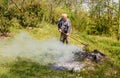 Senior man is burning dry branches in the garden Royalty Free Stock Photo