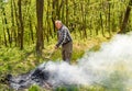 Senior man is burning dry branches in the garden Royalty Free Stock Photo