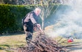 Senior man is burning dry branches Royalty Free Stock Photo