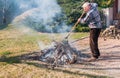 Senior man is burning dry branches Royalty Free Stock Photo