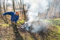 Senior man is burning dry branches in the garden, autumn season Royalty Free Stock Photo