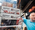 Senior man buying press reactions to French legislative election