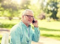 Senior man calling on smartphone at summer park Royalty Free Stock Photo