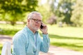 Senior man calling on smartphone at summer park Royalty Free Stock Photo