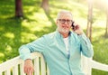 Senior man calling on smartphone at summer park Royalty Free Stock Photo