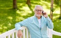 Senior man calling on smartphone at summer park Royalty Free Stock Photo