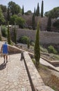 Senior man with cane practices hiking on old town, Toledo, Spain