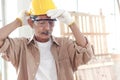 Senior man carpenter working in carpentry woodwork workshop, old craftsman with safety glasses wearing yellow helmet, enjoy his Royalty Free Stock Photo