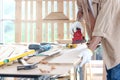 Senior man carpenter working in carpentry woodwork workshop, old craftsman working with electric grinder on wood and enjoy his DIY Royalty Free Stock Photo