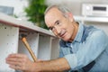 senior man carpenter working with chisel at home Royalty Free Stock Photo