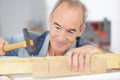 senior man carpenter working with chisel in workshop Royalty Free Stock Photo