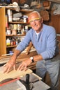 Senior Man Carpenter Working with Wood