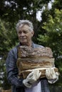 Senior man carrying firewood Royalty Free Stock Photo