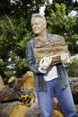 Senior man carrying firewood logs