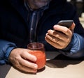 Senior man in casual clothes using mobile phone