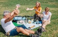 Senior man celebrating that he has won his family playing cards during an excursion Royalty Free Stock Photo