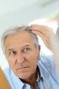 Senior man checking his hair loss Royalty Free Stock Photo