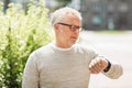 Senior man checking time on his wristwatch Royalty Free Stock Photo