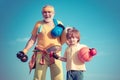 Senior man and child exercising on blue sky. Sport exercise for kids. Portrait of a healthy father and son working out