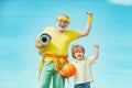 Senior man and child exercising on blue sky. Sports for kids. Sportsman grandfather and healthy kid with basketball ball Royalty Free Stock Photo