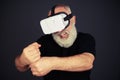 Senior man clenches his fists in virtual reality Royalty Free Stock Photo