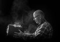 Old man with dusty book