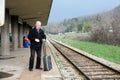 Senior man coming with luggage on the railway station Royalty Free Stock Photo