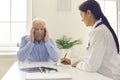 Senior man complaining about headache, stress or blurred eyesight during medical interview