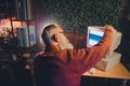 Senior man concentrating on an old computer screen in a cozy office environment during an evening light setting Royalty Free Stock Photo