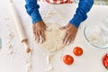 Senior man cooking pizza dough with hands at kitchen Royalty Free Stock Photo