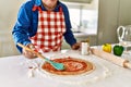 Senior man cooking pizza at kitchen Royalty Free Stock Photo