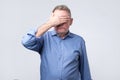 Senior man covering his eyes. He is upset Royalty Free Stock Photo