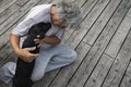 Senior man cuddling with black labrador puppy Royalty Free Stock Photo