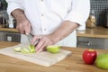 Senior man cutting apples in the kitchen. Conceptual image Royalty Free Stock Photo