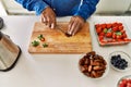 Senior man cutting datil at kitchen Royalty Free Stock Photo