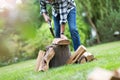 Senior man cutting logs with axe in yard focus on axe Royalty Free Stock Photo