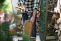 Senior man cutting logs with axe in yard focus on axe Royalty Free Stock Photo