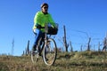 Senior man cycling through abandoned vineyard hills Royalty Free Stock Photo