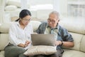 Senior man and daughter using laptop on sofa Royalty Free Stock Photo