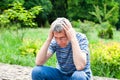 Senior man in depression sitting in the park and holds head his hands. Old age, loneliness, depression, problems. Close-up Royalty Free Stock Photo