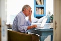 Senior Man At Desk Working In Home Office With Laptop Royalty Free Stock Photo