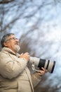 Senior man devoting time to his favorite hobby - photography