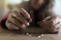 Senior man with dirty hands counting coins Royalty Free Stock Photo