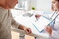 Senior man and doctor with cardiogram at hospital Royalty Free Stock Photo