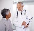 Senior man doctor with patient, clipboard for information and medical forms during consultation. Healthcare, old woman