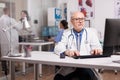 Senior man doctor working on computer Royalty Free Stock Photo