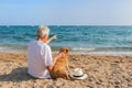 Senior man with dog at the beach Royalty Free Stock Photo