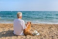 Senior man with dog at the beach Royalty Free Stock Photo