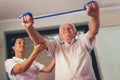 Senior man doing exercises using a strap Royalty Free Stock Photo