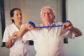 Senior man doing exercises using a strap Royalty Free Stock Photo